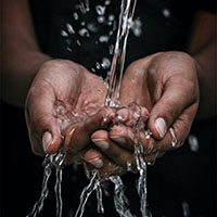 water poured over cupped hands