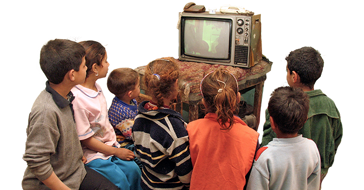 A group of children watching an old TV