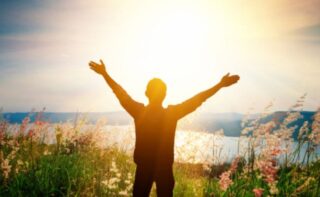 Silhouette of man raising his arms in praise: Trusting in God's Plan