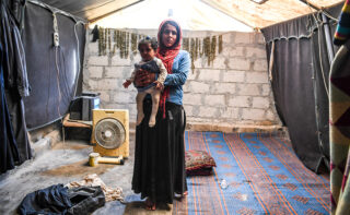 Mother and baby in refugee camp in syria